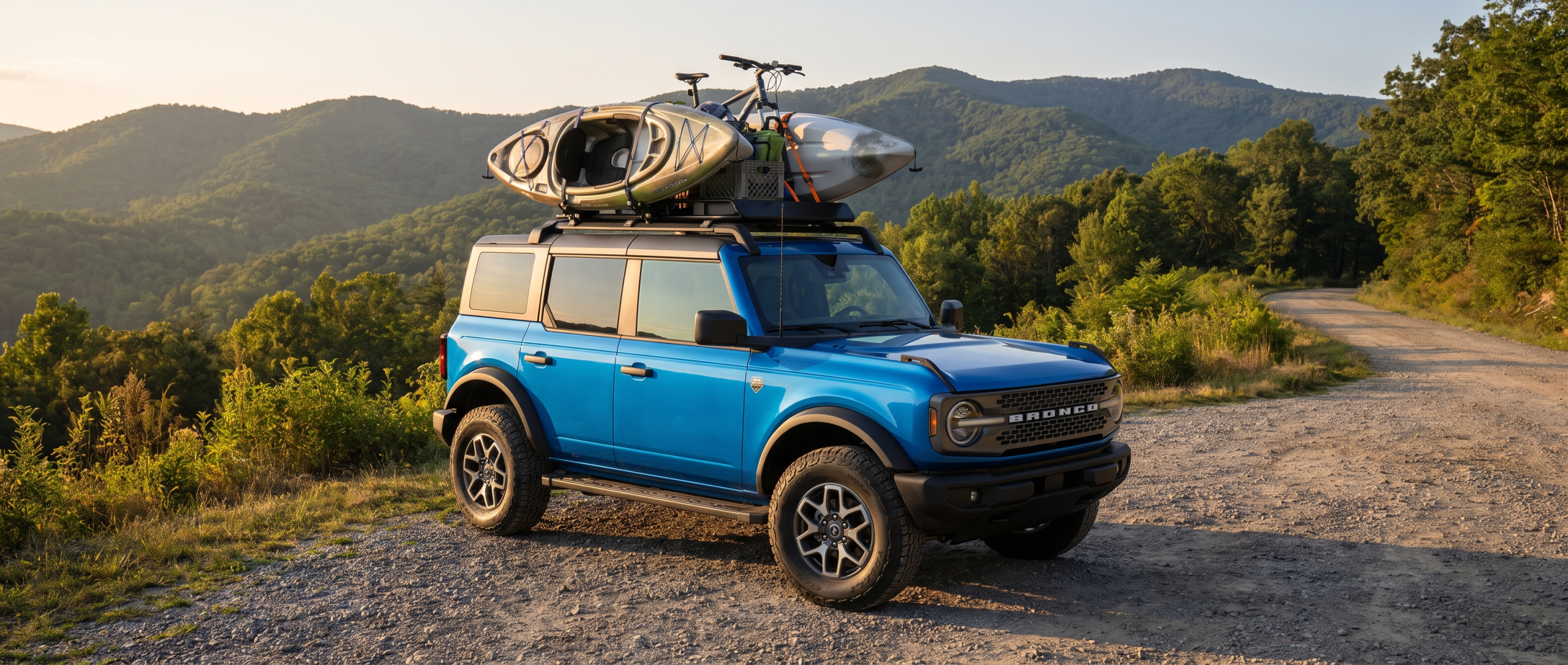 2026 Ford Bronco 4-door on a gravel overlook along the Cherokee Foothills National Scenic Highway, Upstate South Carolina Blue Ridge Escarpment in the background