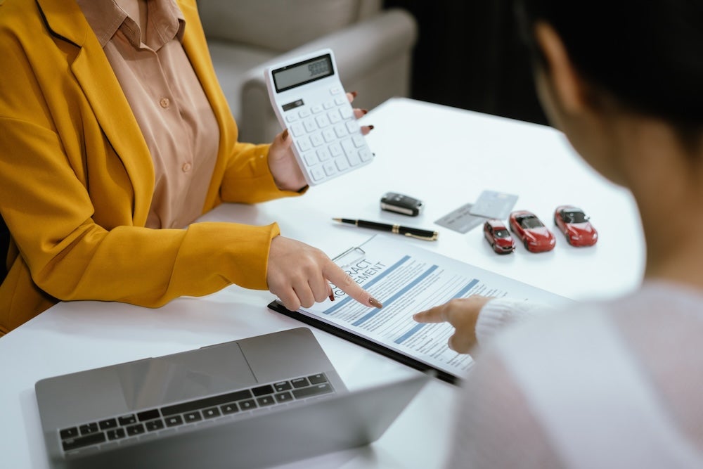 woman helping calculate car financing